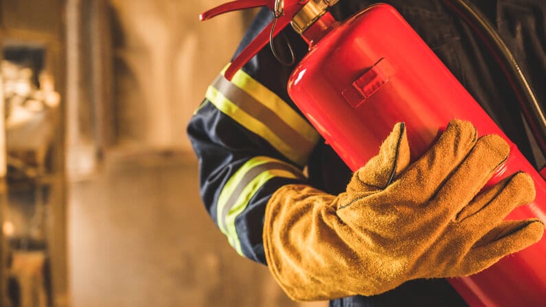 Fireman holding a fire extinguisher