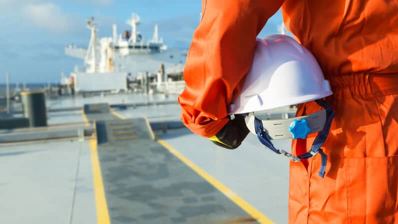 Safety Officer holding his helmet on deck