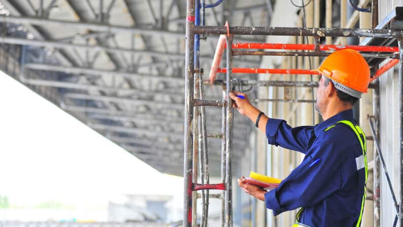 male scaffold inspector checking the scaffolding