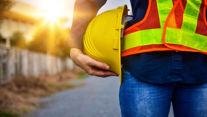 safety aware worker holding a hardhat