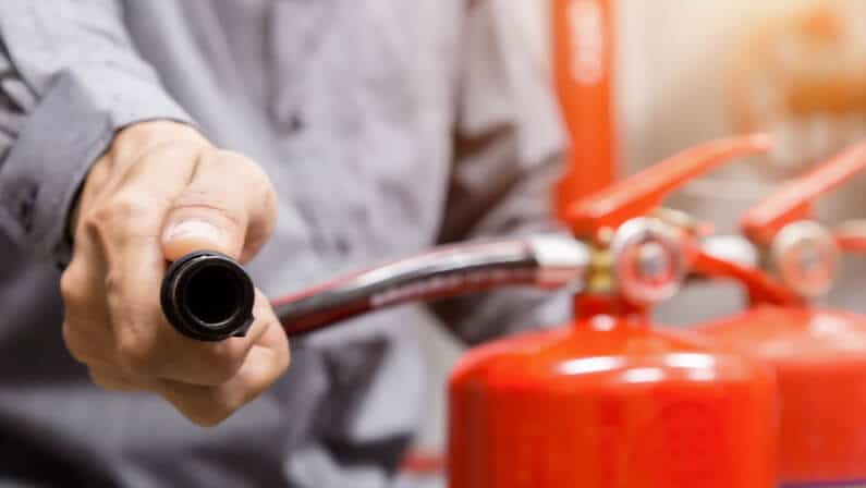 person inspecting fire extinguishers