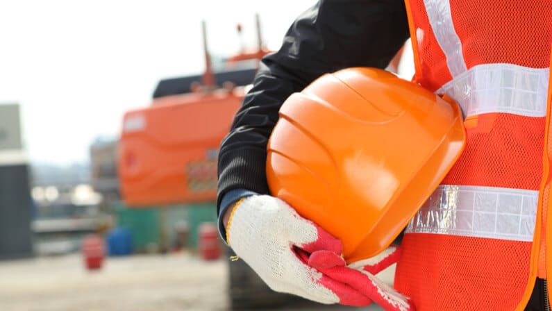 worker holding safety hat